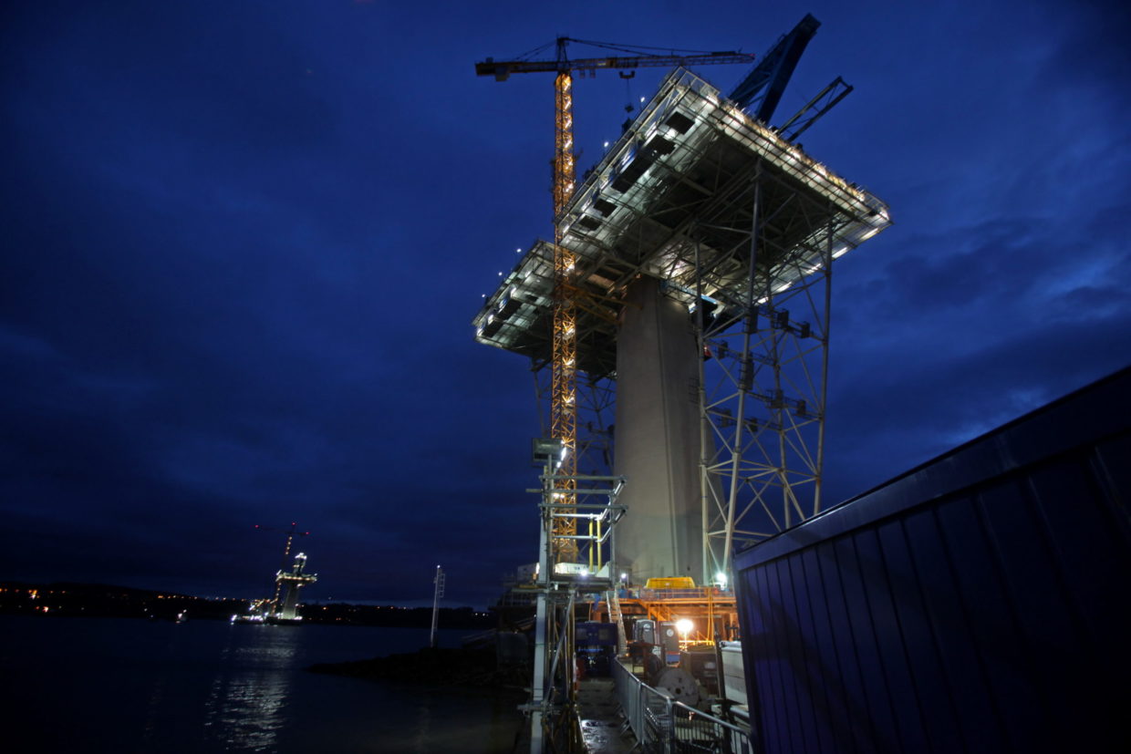 Photo of a bridge construction part from frog-perspective at nighttime.