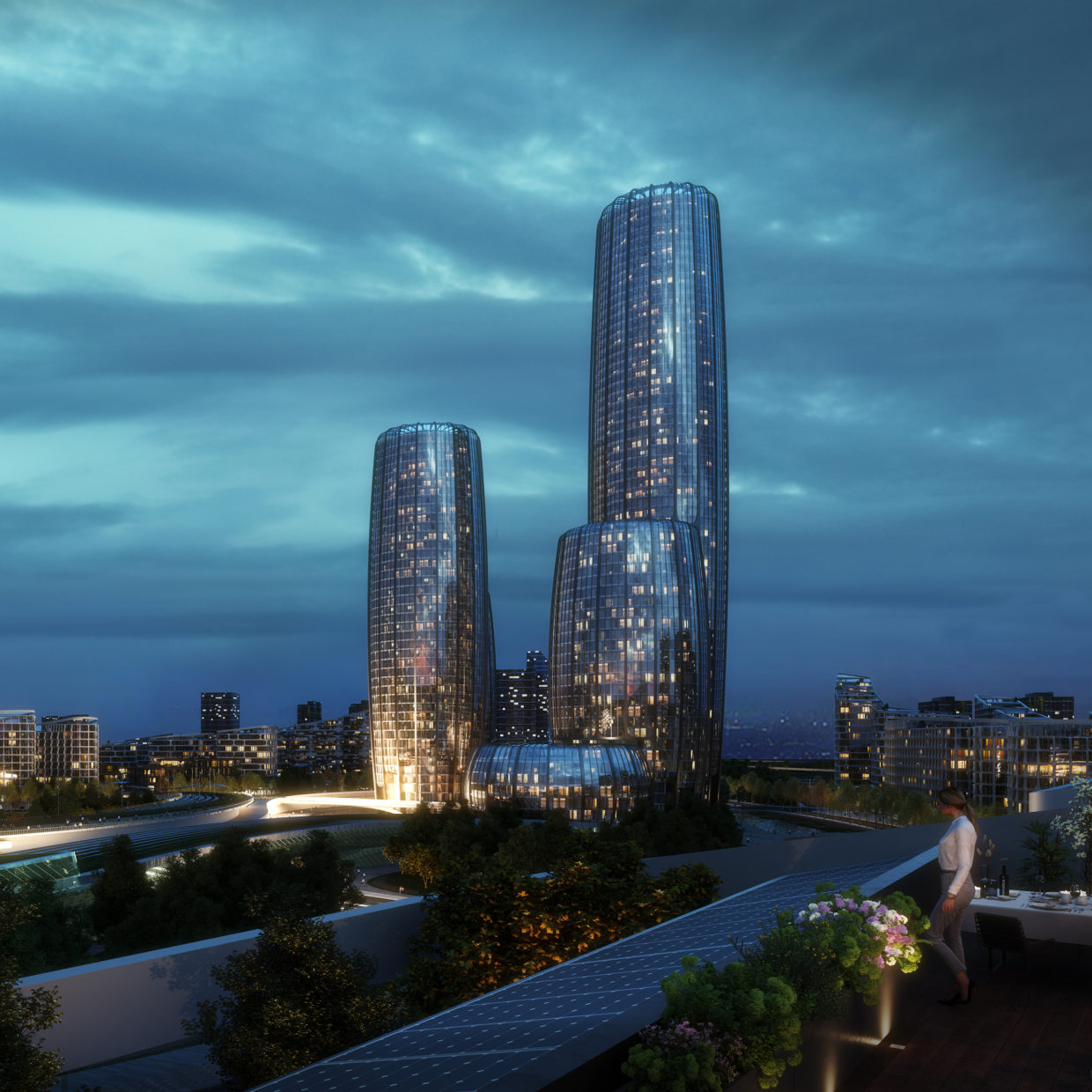 Shot from a terrace of three modern, round skyscrappers at nighttime.