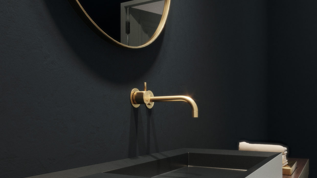 Detail of sophisticated golden bathroom fittings on a dark wall.