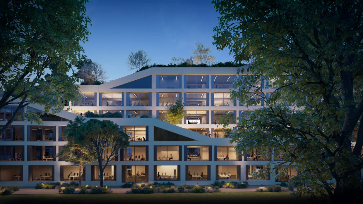 Illuminated, modern office building with bug windows and a large rooftop garden, surrounded by big trees.